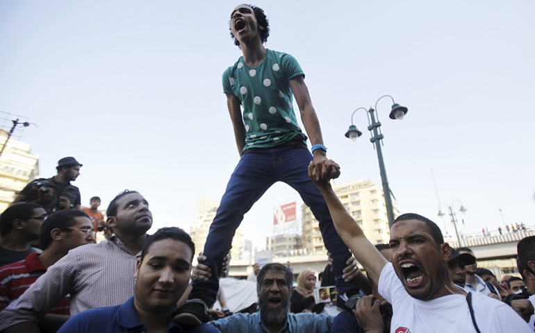 Supporters of the Muslim Brotherhood and ousted Egyptian President Mohammed Morsi shout slogans against the military and interior ministry during a protest in front of Al Istkama mosque in Giza Square, south of Cairo, Aug. 18. (CNS/Reuters/Amr Abdallah Dalsh)