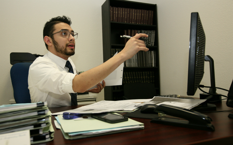 Legal assistant Enrique Chavira, a DACA recipient, helps gather information from other immigrants in the law office of Tania Rosamond in Austin, Texas. Although his immigration status may change after Donald Trump takes office, he vowed to stay optimistic and keep working for clients. (GSR photo / Nuri Vallbona)