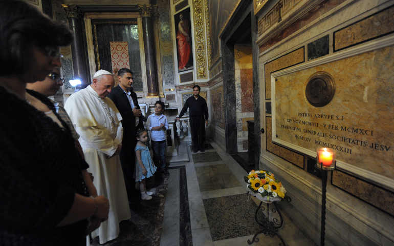 Pope Francis prays at the tomb of Father Pedro Arrupe, superior general of the Jesuits from 1965 to 1983, in the Church of the Gesu in Rome Sept. 10. NCR has started a new blog, The Francis Chronicles, http://ncronline.org/blogs/francis-chronicles to report on the ministry of the world's parish priest. Get to know the pastoral side of Francis. (CNS photo/Alessia Giuliani, Catholic Press Photo)