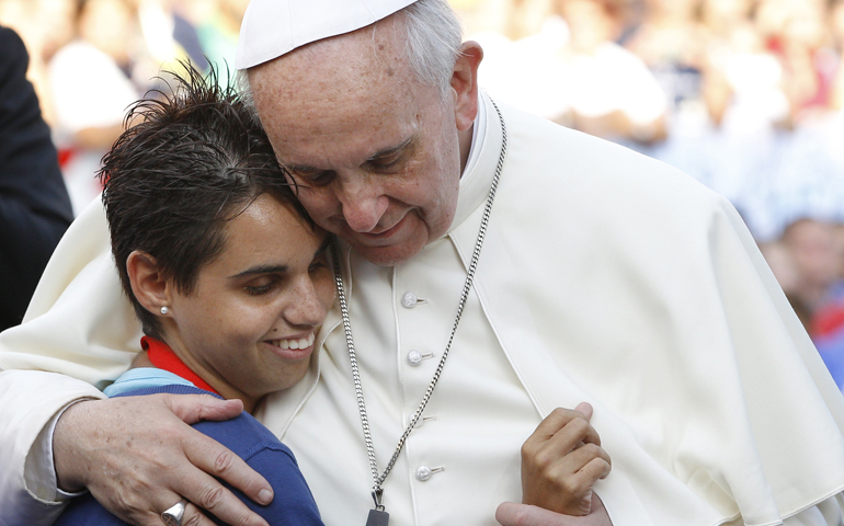 Pope Francis embraces a young woman during an encounter with youth in Cagliari, Sardinia, Sept. 22. (CNS/Paul Haring)