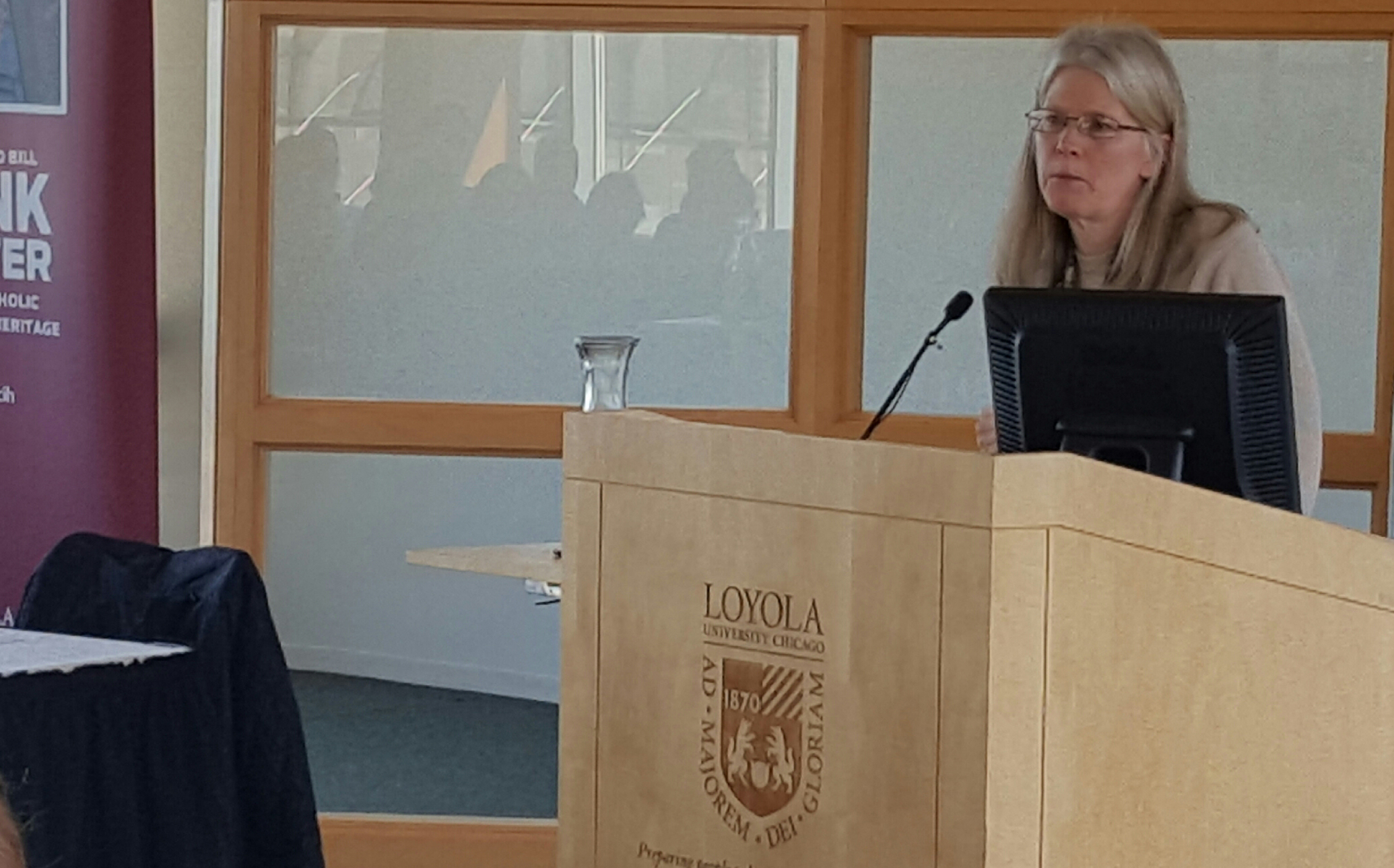 Kate Hennessy, the youngest granddaughter of Dorothy Day, addresses a symposium at Loyola University Chicago. (Heidi Schlumpf)