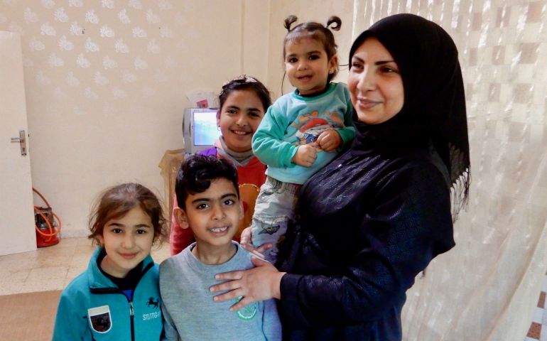 Hanaa Abdullah poses with her children and her brother's children in her brother's apartment in Madaba, Jordan. Abdullah and her brother both fled Syria and now live in rental apartments in the city but have difficulty making ends meet and getting the services they need. (GSR photo/Melanie Lidman)