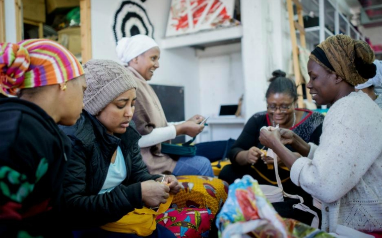 Eden, second from left, is one of the asylum seeker leaders who teach new members how to crochet baskets at the Kuchinate workshop and store in south Tel Aviv, Israel. (Flash90 Photo Agency / Miriam Alster)