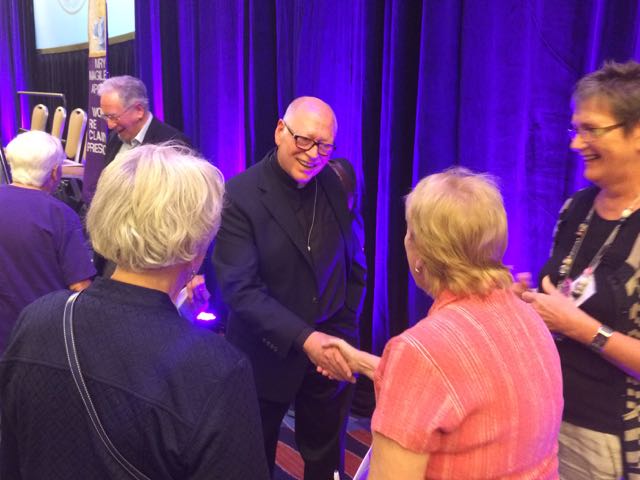 Fr. Jack McClure greets women after WOW panel. (NCR photo/Tom Fox)