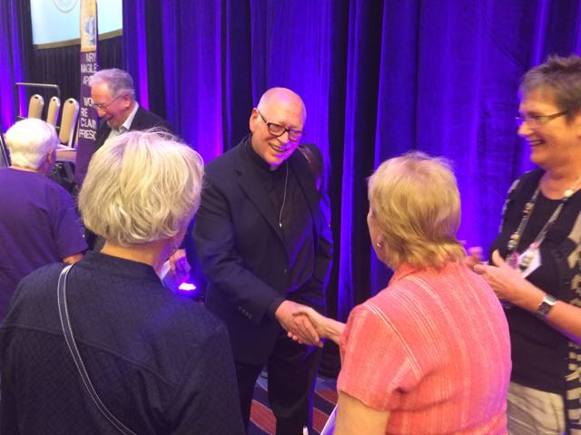 Fr. Jack McClure greets women after WOW panel. (NCR photo/Tom Fox)