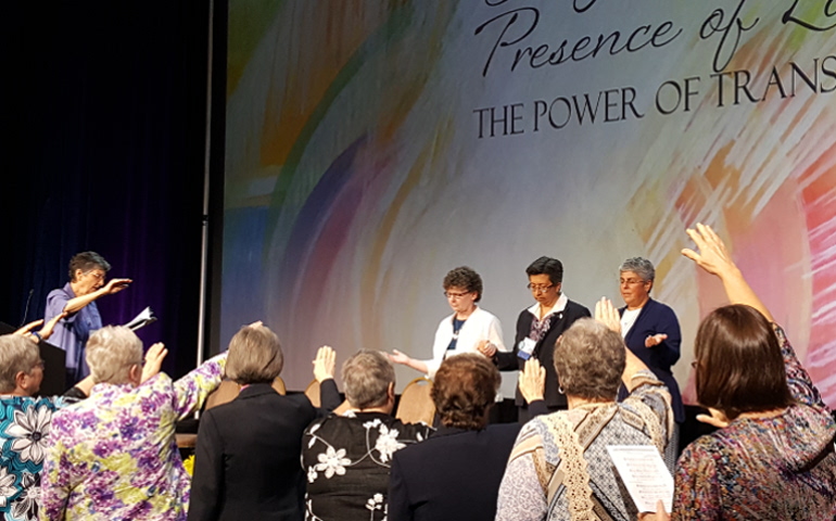Members of the Leadership Conference of Women Religious blesses its leadership team on Aug. 11, 2017, the closing day of the group's annual assembly in Orlando, Florida. From left: Holy Cross Sr. Sharlet Wagner, president-elect; Sister of Charity of the Incarnate Word Teresa Maya, president; St. Joseph Sr. Mary Pellegrino, past-president. (GSR photo / Gail DeGeorge)
