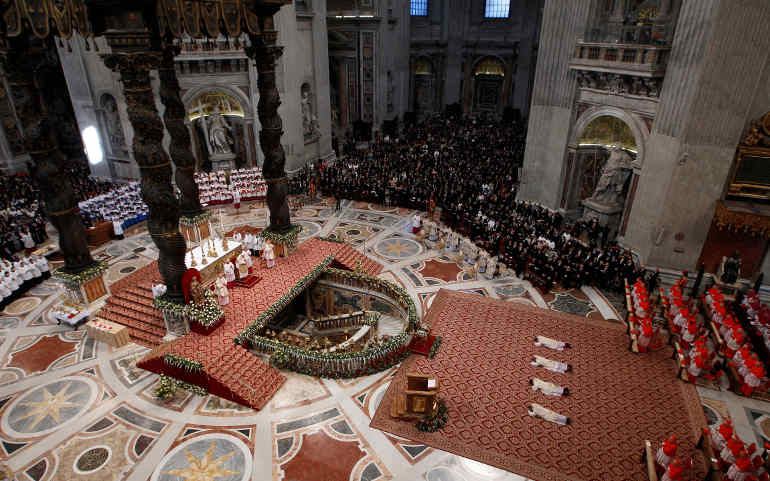 Four new archbishops lie prostrate during their ordination by Pope Benedict XVI in St. Peter's Basilica at the Vatican Jan. 6. Those ordained were: Nicolas Thevenin, apostolic nuncio to Guatemala; Georg Ganswein, prefect of the papal household and the pope's personal secretary; Fortunatus Nwachukwu, nuncio to Nicaragua; and Angelo Zani, the new secretary of the Congregation for Catholic Education. (CNS/Paul Haring)