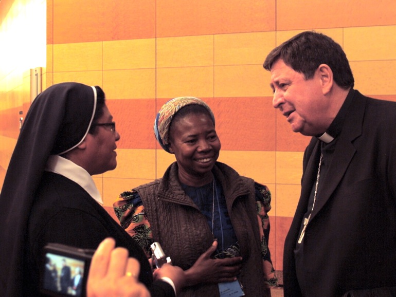 Cardinal João Braz de Aviz, prefect of the Vatican Congregation for Religious, is seen with two assembly participants.(NCR photo/Robyn J. Haas)