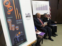 Archbishop Charles Chaput, right, sits with Jack Quindlen during a Jan. 6 news conference to announce that 48 diocesan schools in Philadelphia will close or merge. (Reuters/Mark Blinch)