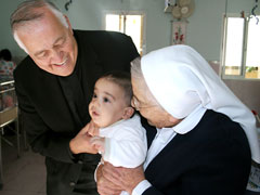 Msgr. John Kozar visits the Holy Family Children's Home, also known as the Creche of Bethlehem. (CNEWA)