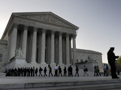 People enter the Supreme Court building in Washington March 26 to attend oral arguments in challenges to the Patient Protection and Affordable Care Act. (CNS/Jonathan Ernst)
