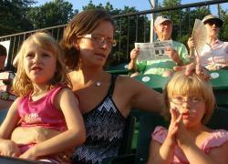 Devin Mitchell, right, watches a baseball game in Bethesda, Md., with her mother, Gena, and younger sister, Emily. (Photos by Alice Popovici)