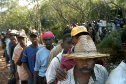 Men wait to work at a sugar plantation. (Walter Astrada)
