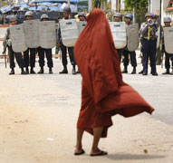A monk stands after being halted by riot policemen and military officials while he and others attempted to enter the Shwedagon Pagoda in Yangon, Burma, Sept. 26, 2007. (Reuters)