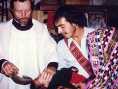 Fr. Stanley Rother is shown baptizing a child in this undated photo. In 2007, the Oklahoma City archdiocese formally launched the cause for canonization of the priest many believe was martyred for his faith. (CNS)