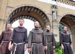 A group of Franciscan friars who walked 300 miles from Virginia to Mount St. Sepulchre, the Franciscan Monastery of the Holy Land in Washington, are pictured outside the monastery July 31. From left to right are Fr. Mark Soehner and Brs. Joshua Van Cleef, Roger Lopez, Richard Goodin and Clifford Hennings. (CNS/Rafael Crisostomo, Catholic Standard)