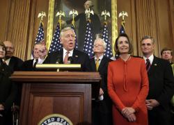 U.S. House Majority Leader Steny Hoyer, D-Md., speaks from a podium next to House Speaker Nancy Pelosi, D-Calif., during a news conference about the House vote on health care reform on Capitol Hill in Washington Nov. 7. (CNS/Reuters/Yuri Gripas)