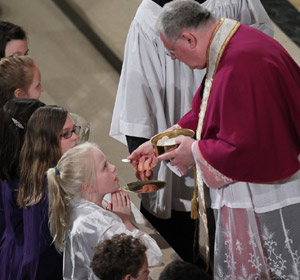 Children receive Communion during a 2010 pontifical solemn high Mass at the Basilica of the National Shrine of the Immaculate Conception in Washington. (CNS/Nancy Wiechec)