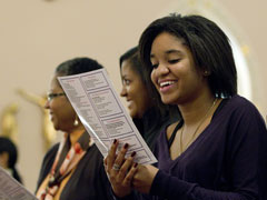 Alyssa Brooks smiles as the congregation recites a newly worded response at the beginning of Mass at St. Joseph's Catholic Church in Alexandria, Va., Nov. 27. (CNS/Nancy Phelan Weichec)