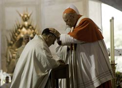 Cardinal William Levada, former San Francisco archbishop, places his hands on Auxiliary Bishop Robert McElroy during his ordination Mass at St. Mary's Cathedral in San Francisco Sept. 7. (CNS/Catholic San Francisco/Jose Luis Aguirre)