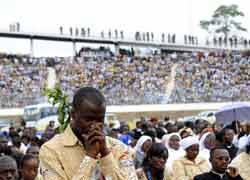 A man prays during Mass celebrated by Pope Benedict XVI at Amadou Ahidjo Stadium in Yaounde, Cameroon, March 19. (CNS/Reuters)