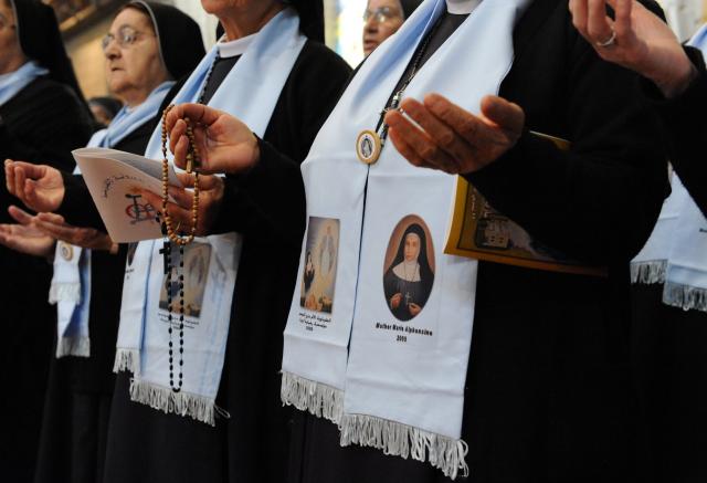 Nuns pray at the beatification Mass of Blessed Mother Marie-Alphonsine Ghattas, Nov. 22. (CNS/Debbie Hill)