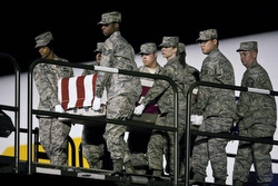 The coffin containing the body of U.S. Air Force Staff Sgt. Phillip Myers is carried by a transfer team at Dover Air Force Base in Dover, Del., in April 2009. (CNS photo/Joshua Roberts, Reuters)