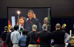 Deputies to the Episcopal General Convention watch a screen as the Very Rev. David Thurlow of South Carolina addresses the convention in Indianapolis July 10. The convention approved a rite of blessing for same-sex unions, making the Episcopal Church th e largest U.S. denomination to do so. Rev. Thurlow spoke against adoption of the blessing, saying it was a departure from the church's teaching on marriage. (CNS photo/Mary Frances Schjonberg, courtesy of Episcopal News Service)