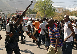 A policeman argues with men during a march and protest against the Haitian government in Port-au-Prince Feb. 7. (CNS photo/Eduardo Munoz, Reuters)
