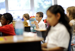 Second-grade students pray during the first day of school at St. John Neumann in Rochester, N.Y., Sept. 8. (CNS photo/Mike Crupi, Catholic Courier)