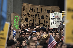 Demonstrators from the Occupy Wall Street campaign hold signs as a protest march enters the courtyard near the New York Police Department headquarters Sept. 30. (CNS photo/Lucas Jackson, Reuters)
