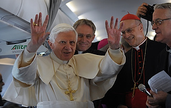 Pope Benedict XVI waves to journalists aboard a plane on the way to Edinburgh, Scotland, Thursday. (CNS photo/Alessia Giuliani, Catholic Press Photo)