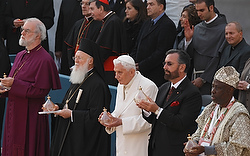 Religious leaders hold oil lamps during the gathering for peace outside the Basilica of St. Francis in Assisi Oct. 27. Pictured from left are: Anglican Archbishop Rowan Williams of Canterbury; Ecumenical Patriarch Bartholomew of Constantinople; Pope Bene dict XVI; Rabbi David Rosen, representing the chief rabbinate of Israel; and Wande Abimbola, representative for the traditional religion of Nigeria's Yoruba people. (CNS photo/Paul Haring)