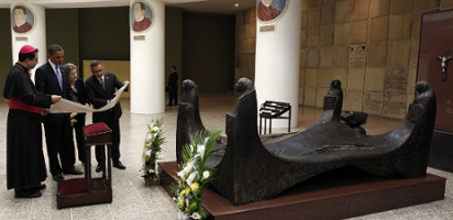 U.S. President Barack Obama stands with San Salvadoran Archbishop Jose Escobar Alas, a translator, and El Salvador's President Mauricio Funes beside the tomb of Archbishop Romero, who was shot dead by a hit squad while celebrating Mass in the capital March 24, 1980.(CNS photo/Kevin Lamarque, Reuters)