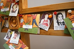 A cross outside the U.S. bishops' Office of Child and Youth Protection is covered with photos and prayers for the victims of clergy sexual abuse. (CNS photo/Nancy Wiechec)