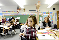 Fourth-grader Shannon Lawless raises her hand to answer a question Dec. 20 at Christ the King School in Irondequoit, N.Y. (CNS photo/Mike Crupi, Catholic Courier)