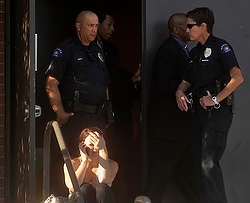 People react outside Gateway High School a few blocks from the scene of the Century 16 theater shootings in Aurora, Colo. (CNS/Reuters/Evan Semon)
