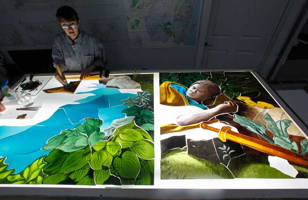 Artist Bronna Butler works on a section of stained glass project for the Maryrest Mausoleum on March 13. (RNS/Noah K. Murray/The Star Ledger)