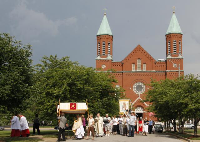 Parishioners at St. Stanislaus Kostka Church in St. Louis process outside the church during a celebration of the Feast of Corpus Christi in 2011. (Photo courtesy of Patricia Darek)