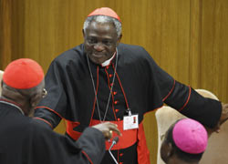 Cardinal Peter Turkson of Cape Coast, Ghana, center, talks with other participants of the Synod of Bishops for Africa at the Vatican Oct. 6. (CNS/Paul Haring)