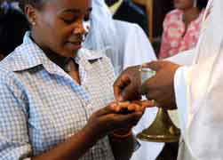 A woman receives Communion during Mass at St. Therese of the Child Jesus Parish in Yaounde, Cameroon, in this Feb. 1 file photo. (CNS photo/Alessia Giuliani, Catholic Press Photo)