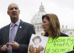 Barbara Blaine displays a picture of herself as a child and a banner saying, "Expose the Truth! Stop Secrecy," at a 2010 demonstration in St. Peter's Square. With her is Peter Isely. (CNS/ Reuters)