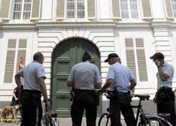 Police officers stand outside the residence of the archbishop of Mechelen-Brussels in Mechelen, Belgium, June 24. (CNS/Reuters)