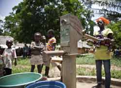 People fill buckets with water from a pump in the Liberian border village of Sawien in this photo released to Reuters April 4. Caritas Ivory Coast helped care for some of the million people displaced by the violence Ivory Coast in March and April.