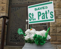 A "saved" sign is seen outside St. Patrick Church in Cleveland March 8. Closed in 2010, St. Pat's was among 27 churches shuttered in a reconfiguration plan under Bishop Richard G. Lennon. A Vatican congregation has overturned the closing of 13 of those c hurches and said they must be restored for worship. (CNS photo/William Rieter)