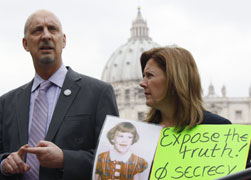 Peter Isely, left, speaks to journalists as Barbara Blaine displays a picture of herself as a child and a banner saying, "Expose the Truth! Stop Secrecy," as they take part in a demonstration against child sexual abuse by clergy, in St. Peter's Square at the Vatican March 25. (CNS photo/Alessandro Bianchi, Reuters)
