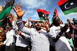 Libyans celebrate in Tripoli's Martyrs Square after hearing news that Libya's ousted leader Moammar Gadhafi was killed by fighters in Sirte, Libya, Oct. 20. (CNS photo/Ismail Zitouni, Reuters)