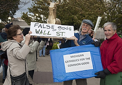 Activists show off a golden calf at the kick off for "Occupy Detroit" on Oct. 10. (CNS photo/Jim West)
