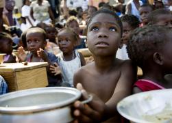 A child waits for a meal to be distributed by the U.N. World Food Program in a makeshift camp in Jacmel, Haiti, Jan. 28. (CNS photo)