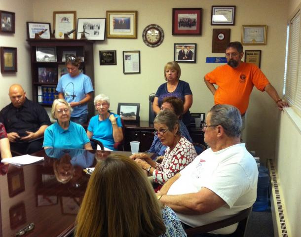 Alice Kitchen, co-member of the Loretto sisters, explains the Nuns on the Bus mission to two of Congressman Todd Akin's staff at his St. Louis County office Thursday. (NCR photo/Holly Edgell)